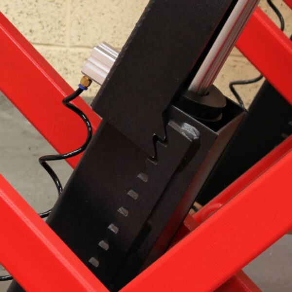 Close up shot of the air powered safety locks on a flush mounted scissor lift